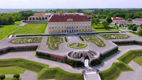 People-Taking-Tour-In-Front-Of-The-Baroque-Style-Architecture-Of-Schloss-Hof-Palace-In-Marchfeld,-Austria