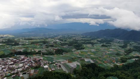 Rainy-weather-above-Indonesia-village-and-fields,-aerial-drone-view