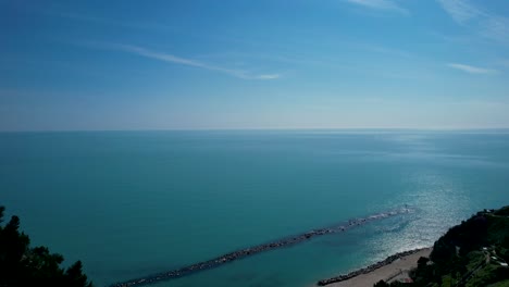 Adriatic-Sea-breaking-in-Spiaggia-del-Frate,-in-Numana-village,-Italy-drone-aerial-footage
