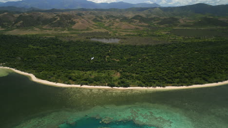 Looking-down-on-plane-flying-over-Poé-Beach,-Shark-Fault,-Grande-Terre,-New-Caledonia