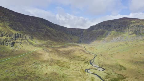 Drone-reveal-of-the-majestic-Mahon-Valley-with-the-Mahon-Falls-at-the-head-of-the-Valley-and-The-Mahon-River-flowing-to-the-sea-Comeragh-Mountains-Waterford-Ireland