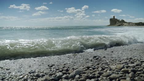 Surprise-wave-in-slow-motion-on-the-shore-of-a-Mediterranean-beach,-El-charco,-Villajoyosa,-Alicante,-spain