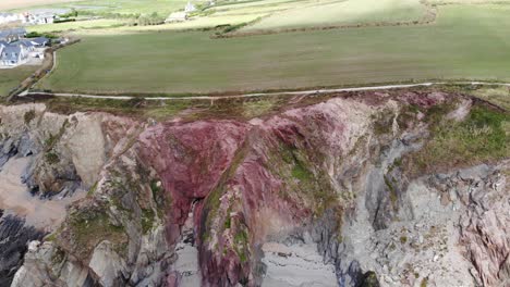 Aerial-Dolly-View-Across-Dramatic-Eroded-Cliffs-At-Thurlestone