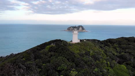 Aerial-View-Of-East-Cape-Lighthouse-On-Otiki-Hill-With-Whangaokeno-In-The-Distance-In-New-Zealand