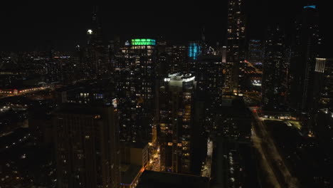 Drone-shot-around-deluxe-apartment-buildings-in-South-Loop,-night-in-Chicago,-USA