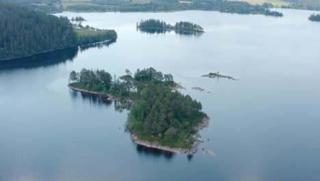Aerial-Drone-View-Of-A-Small-Island-In-Peaceful-Lake
