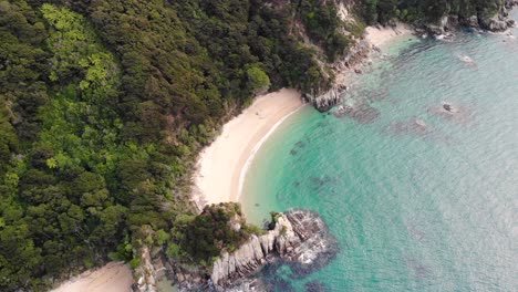 Remoted-sandy-beach-in-paradise-aerial-tilt-down-reveal-shot