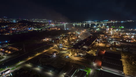 Nighttime-aerial-hyper-lapse-of-the-SLN-nickel-smelting-factory-in-Nouméa,-New-Caledonia