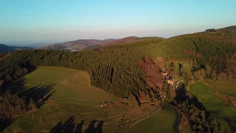 Drone-View-Of-French-Countryside-With-Forest,-Hills-And-Domain-In-Ardèche-under-the-sunset