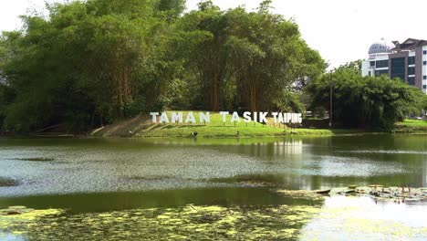 Landscape-shot-at-popular-recreational-park-located-in-Taman-Tasik-Taiping,-Perak,-Malaysia,-capturing-beautiful-scenery-of-serene-lake-garden,-and-lush-greenery
