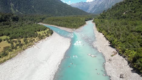 Beautiful-colouful-scene-of-confluence-two-rivers-and-pristine-forest,-New-Zealand-natural-landscape---drone-shot