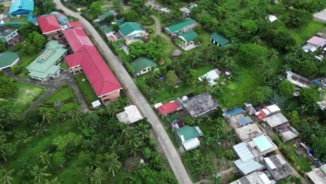 Aerial-View-of-Quaint-Rural-Neighborhood-Village-with-School,-houses-and-quiet-road-in-tropical-island-of-Catanduanes