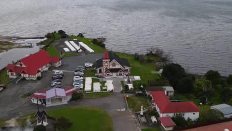 Historic-Anglican-Church-in-Ohinemutu,-Rotorua---aerial-orbit-reveal-heritage-site-in-New-Zealand