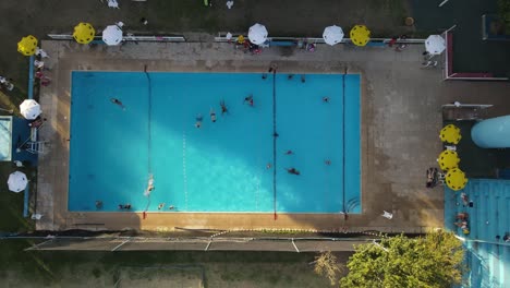 People-in-public-swimming-pool-at-Buenos-Aires-City-at-sunset,-Argentina