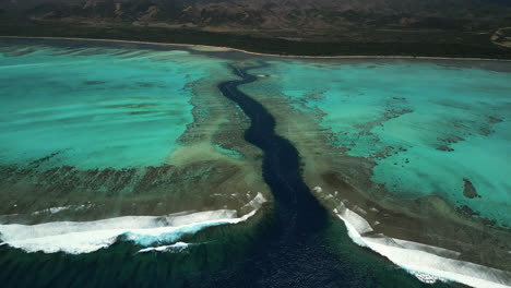 Mouth-of-Shark-Fault,-towards-Poé-Beach,-Grande-Terre,-New-Caledonia-aerial-parallax