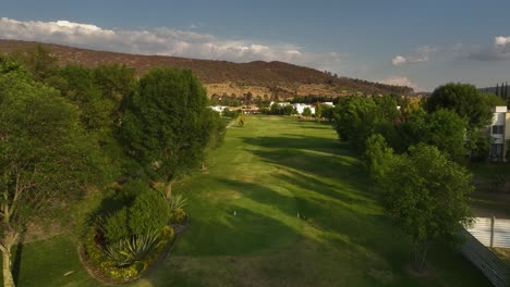 Drone-shot-over-a-Golf-course-at-Hacienda-Cantalagua-in-sunny-Contepec,-Mexico