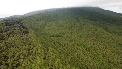 Slopes-of-Central-American-tree-covered-Rainforest-Volcano--Aerial-pull-back