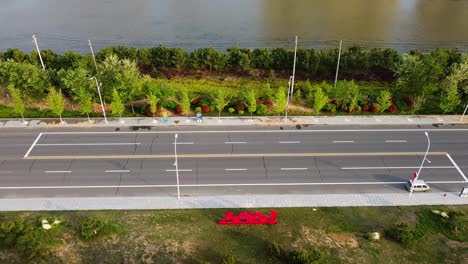 Descending-view-of-highway-traffic-filmed-in-Nanhai-New-District,-Shandong-Province,-China