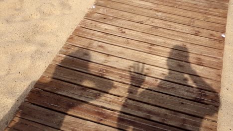 Two-shadows-saying-goodbye-on-the-beach,-dunes-of-Piscinas-in-Sardaigna