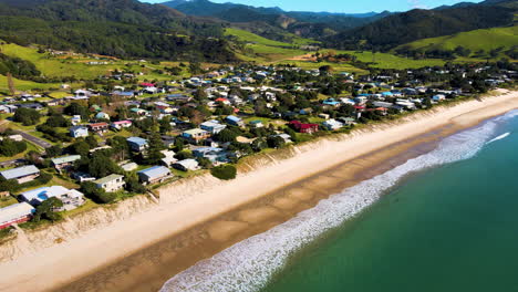 Retail-estate-properties,-beachfront-of-Whangapoua,-Coromandel-peninsula,-New-Zealand---aerial
