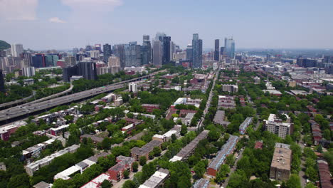 Aerial-rising-shot-of-the-Petite-Bourgogne-district-with-downtown-Montreal-in-background