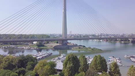 Ascending-4k-aerial-shot-revealing-Ada-bridge-in-Belgrade-and-Ada-lake