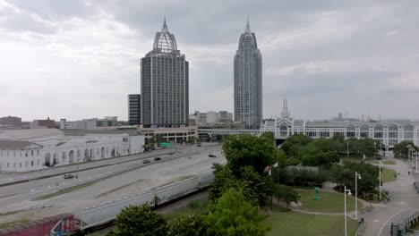 Train-moving-in-downtown-Mobile,-Alabama-with-stable-drone-video
