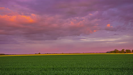 Timelapse-of-clouds-passing-across-sky-over-green-farmland
