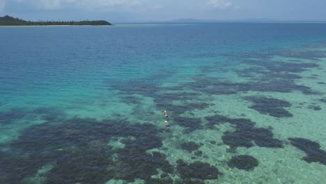 Drone-Fiji-Coral-reef-relaxing-on-boat-to-friends-snorkeling-white-sandbar-Malalo-island-aqua-deep-blue-water-scenic-landscape-sunny-beautiful-relaxing-Nadi-aerial-cinematic-forward-movement