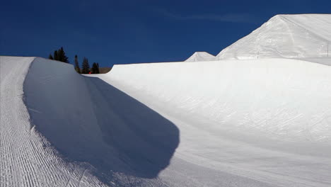 X-Games-Half-Pipe-ski-snowboarding-terrain-park-fresh-groomed-bluebird-sunny-morning-bottom-of-Buttermilk-opening-Aspen-Colorado-slider-movement-right