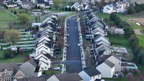 Long-aerial-zoom-descending-shot-of-American-neighborhood-in-late-winter,-early-spring