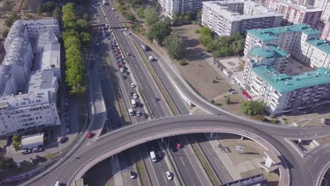 Tilting-aerial-shot-of-New-Belgrade-Roundabout-and-highway,-Genex-tower