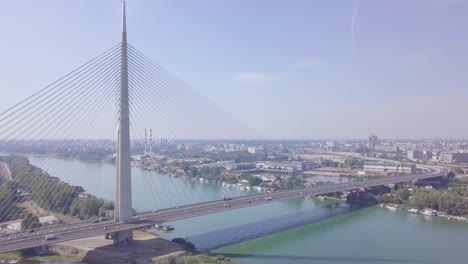 Orbiting-aerial-4k-fast-shot-showing-Sava-river-and-lake-and-Ada-bridge-in-Belgrade
