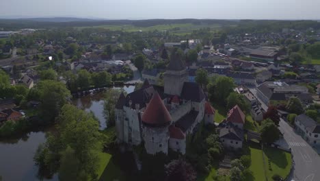 Dramatic-aerial-top-view-flight-Austria-Heidenreichstein-castle-in-Europe,-summer-of-2023