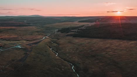 Golden-hour-drone-time-lapse-of-the-sun-setting-over-a-peat-and-bog-moor