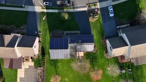 Top-down-descending-shot-of-house-with-solar-panels-in-rural-American-neighborhood