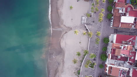 Puerto-Vallarta-Zenith-View:-Calm-Sea,-Warm-Sandy-Beach,-and-Iconic-Boardwalk---Aerial-Drone-Video