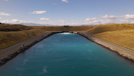 Static-aerial-of-power-canal-with-turquoise-blue-coloured-water
