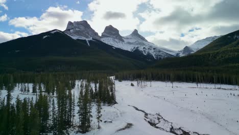 Aerial-of-Three-Sisters-from-Bow-River-Valley,-Canmore,-Alberta,-Canada