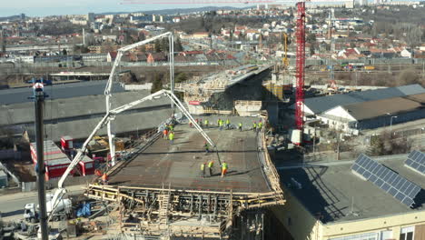 Workers-preparing-crane-cement-pumps-at-city-bridge-construction-site