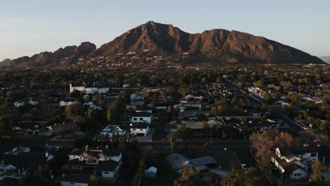 Aerial-view-tilting-up-from-Arizona-houses-to-reveal-Camelback-Mountain