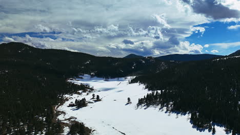 Evergreen-Winter-Hyperlapse-Timelapse-open-field-and-valley-mountain-of-Colorado-clouds-moving-motion-forward