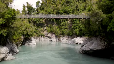 Stunning-view,-natural-wonder-of-pristine-water-in-canyon-native-forest-at-Hokitika-Gorge