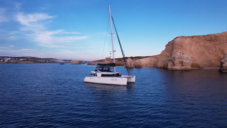 Catamaran-Yacht-anchored-off-the-coast-of-Greek-island
