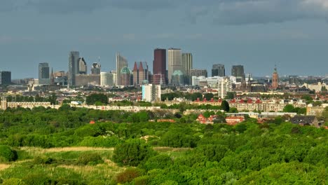 The-Hague-city-skyline-view-against-sky,-wide-aerial-view-from-over-ocean