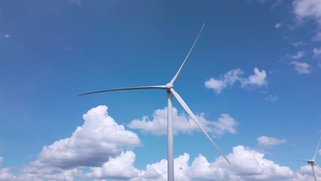 Aerial-circling-motionless-wind-turbines-on-sunny-day