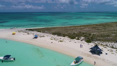 Aerial-traveling-tropical-island-with-people-enjoy-summertime,-beCh-scene-Cayo-de-agua-Los-Roques