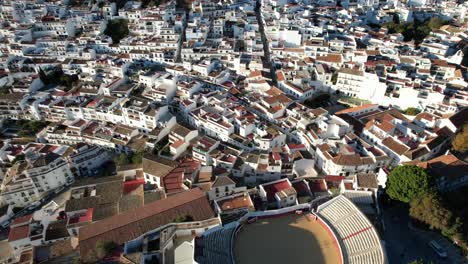 Beautiful-classic-spanish-architecture,-white-buildings-with-tan-roofs-by-mountains