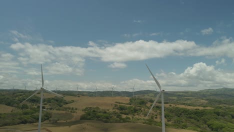 Drone-panning-shots-around-large-wind-turbines-turning-at-Tilaran-wind-farms