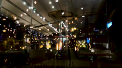 Blurred-Image-Of-Christmas-Lights-Inside-The-Restaurant-With-Heater-On-A-Cold-Night